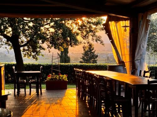 a table and chairs on a patio with a view at Agriturismo Cascina Cipressa in San Romano
