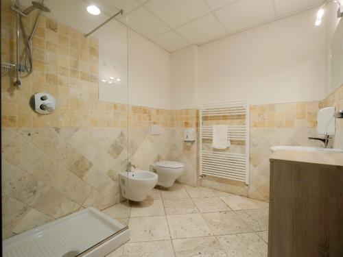 a bathroom with a toilet and a sink and a shower at Hotel Arezzo ASC in Arezzo