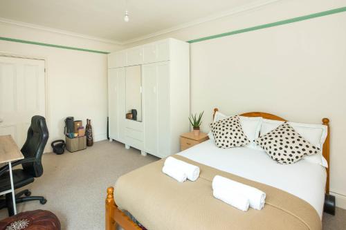 a bedroom with a bed with two pillows on it at Charming apartment one bedroom west london in London