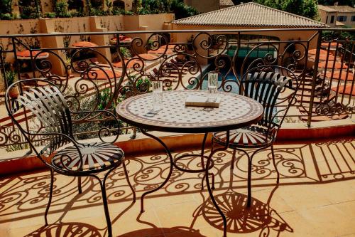 a table and chairs sitting on a patio at Le Mas Candille in Mougins