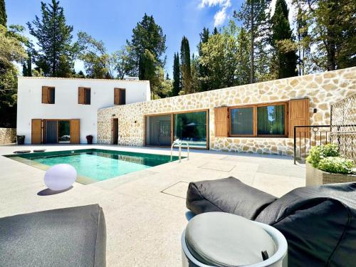 a villa with a swimming pool and a house at Domenico Morani Luxury Villa Concept with private pool by DadoVillas in Gastourion