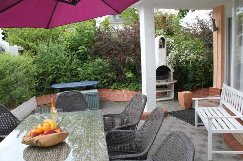 a table with a bowl of fruit on a patio at City Ferienhaus Vulkaneifel in Daun