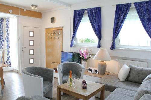a living room with blue curtains and a couch at City Ferienhaus Vulkaneifel in Daun
