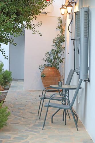 a table and a chair on a patio at Galini Rooms & Apartments in Finikas