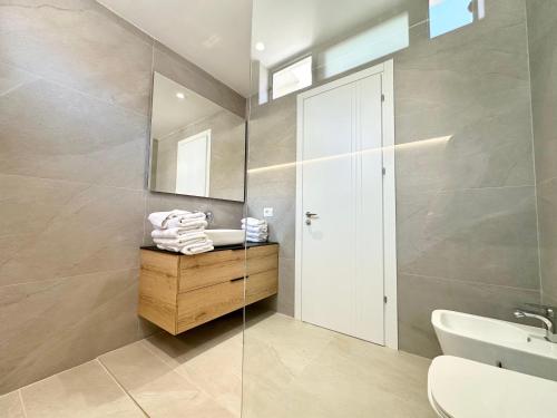 a bathroom with a sink and a mirror at Palmera Resort Saranda - Palmera Villa Resort in Sarandë