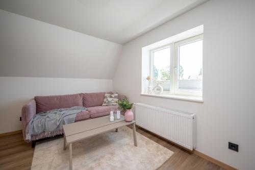 a living room with a couch and a table at Pärnu Pearl Residences in Pärnu