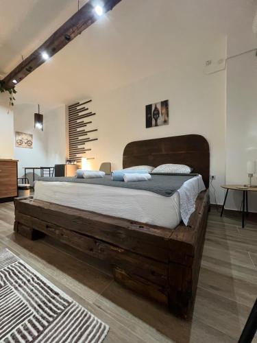 a bedroom with a large wooden bed in a room at LiboroApartments in Niš
