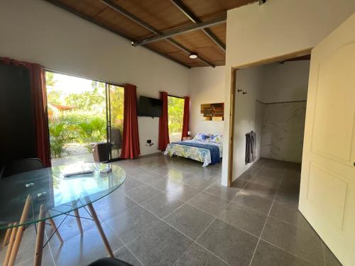 a bedroom with a bed and a glass table at Uvita Oasis Retreat with Villa Cabins and Apartment in Uvita