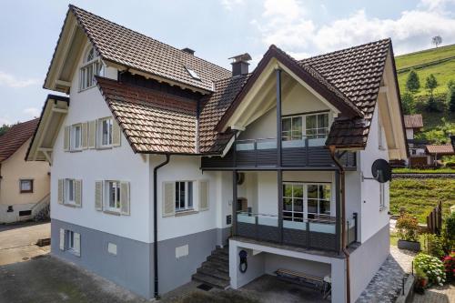 a white house with a brown roof at Moderner Schwarzwaldtraum in Oberharmersbach