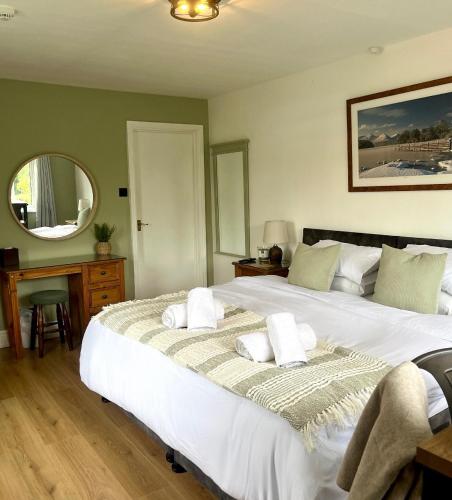 a bedroom with a large bed with two pillows on it at Shemara rooms in Keswick
