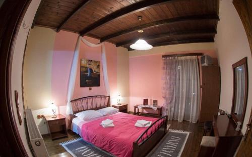 a bedroom with a bed with a red blanket at Dione by Open City in Dhimitsana