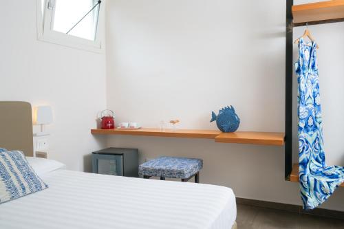 a bedroom with a bed and a stool and a shelf at Santa Maria Vecchia Relais in Vico Equense