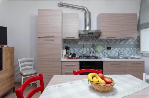 a kitchen with a table with a basket of fruit at Borgo Capobianco in Montefiascone