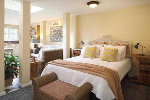 a bedroom with a bed and a chair in a room at Steeple View - Romantic Wye Valley Country House Studio Apartment - Dog Friendly in Newland