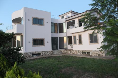 a house with a large yard in front of it at Zografos Studios Zacharo Zakharo in Zakharo