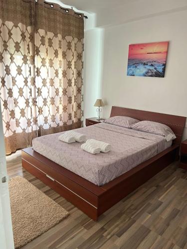 a bedroom with a bed with two towels on it at Torrenostra Apartment in Grao de Castellón