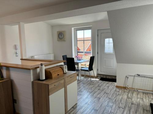 an empty room with a counter and a table with chairs at Ferienwohnung Bad Frankenhausen in Bad Frankenhausen