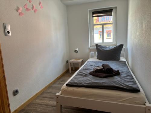 a bedroom with a bed with a towel on it at Ferienwohnung Bad Frankenhausen in Bad Frankenhausen