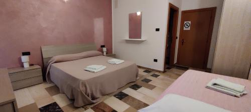 a bedroom with a bed with towels on it at Albergo Drena in Drena