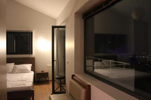 a hotel room with a bed and a window at Zografos Studios Zacharo Zakharo in Zakharo