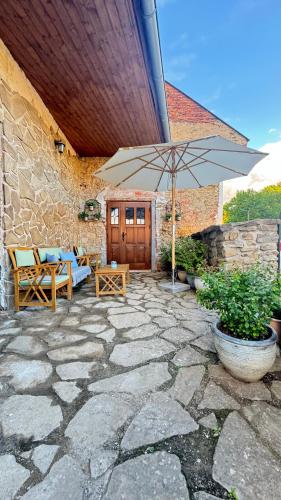 a patio with an umbrella on a stone patio at Dom na hradbách in Levoča