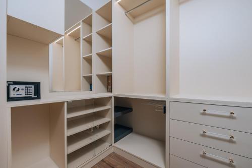a walk in closet with white cabinets at Villa Principium with Infinity Edge Pool&Hot Tub in Kotor