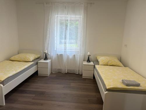 DierdorfにあるNeue Ferienwohnung Dierdorfの窓のある部屋にベッドが2つある