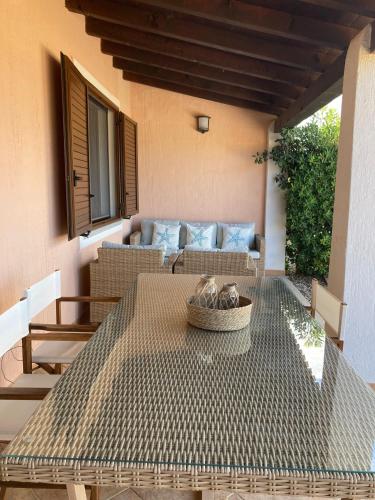 a patio with a table and a couch at Abba Sixty - View, Pool & Parking - 200mt Sea in Tertenìa