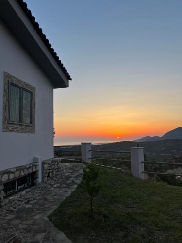 a house with the sunset in the background at Zografos Studios Zacharo Zakharo in Zakharo