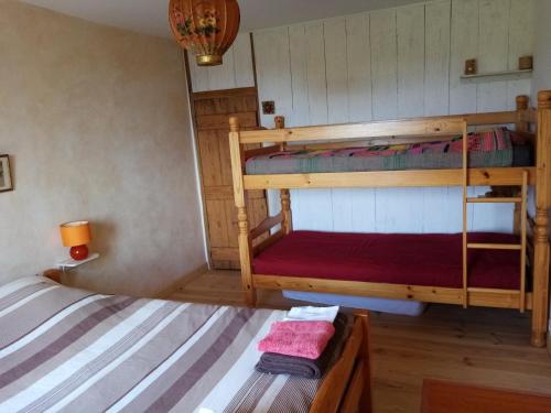 a bedroom with two bunk beds in a house at Chambres D'hôtes LES PAPILLONS in Mars