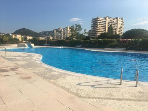 une piscine vide avec des bâtiments en arrière-plan dans l'établissement Cannes Marina swimming pool near Mediterranée sea inland port, à Mandelieu-la-Napoule