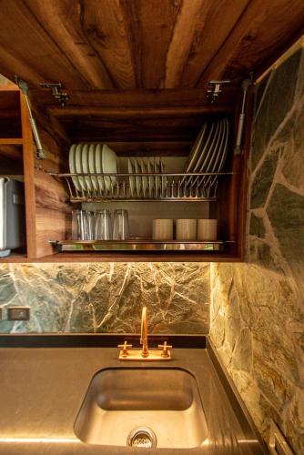 a kitchen sink with a candle on top of it at Cabin Nestled in Bamboo Forest in Armenia