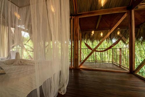 a bedroom with a bed in a room with a window at Cabin Nestled in Bamboo Forest in Armenia