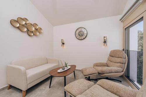 a living room with a couch and two chairs and a table at Villa Principium with Infinity Edge Pool&Hot Tub in Kotor