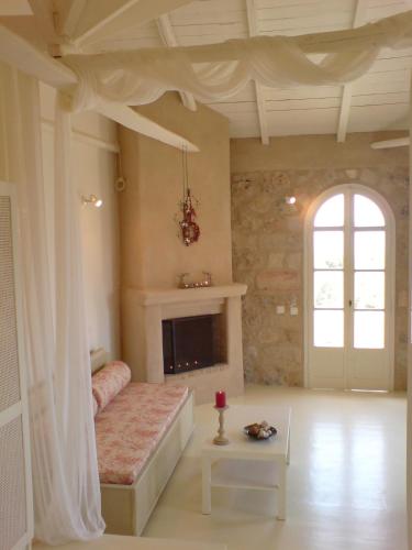 a living room with a bed and a fireplace at Katikies Manis in Kardamili