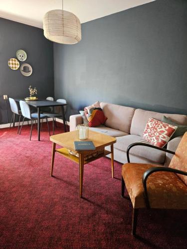 a living room with a couch and a table at Lilla Älvbrogården i stan in Avesta