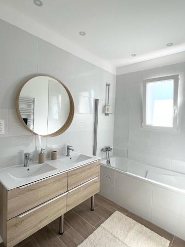 une salle de bain avec un lavabo, une baignoire et un miroir dans l'établissement Villa avec piscine, vue dégagée sur la forêt, à Fuveau