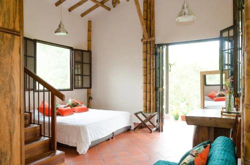 a bedroom with a bed with orange pillows at Charming Coffee Region Farm Escape in Armenia