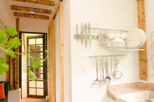 a kitchen with utensils hanging on a wall at Charming Coffee Region Farm Escape in Armenia