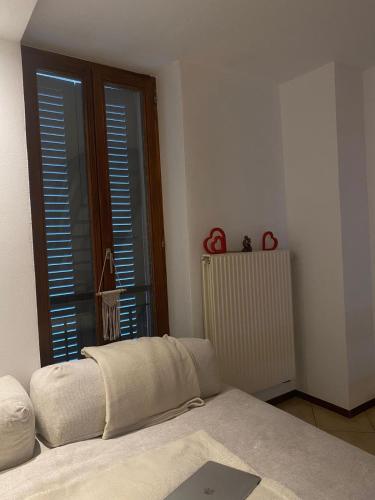 a living room with a couch and a window at Love Stay BELLINZONA in Bellinzona