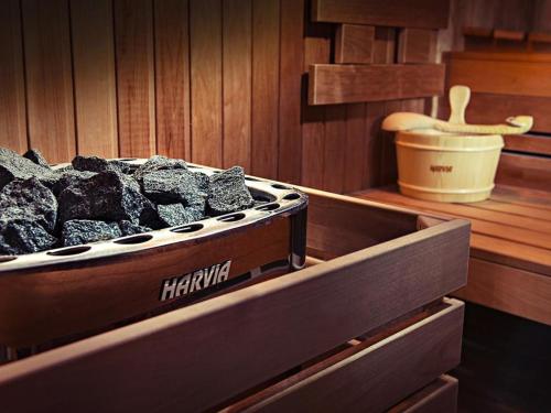 a box of charcoal sitting inside of a sauna at ETO Park Hotel Business & Stadium in Győr