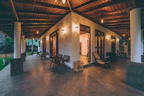 a room with chairs and tables in a building at Villa Sewinro in Talpe