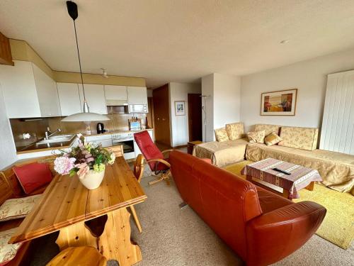 a living room with a couch and a table at Bellevue 518 in La Tzoumaz