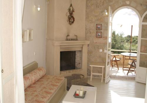 a living room with a couch and a fireplace at Katikies Manis in Kardamili