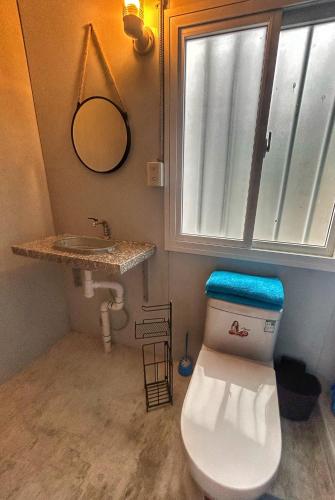 a bathroom with a toilet and a sink at Casa Terra cerca de Playa in Barra de Navidad