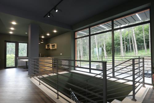 a room with a large window and a large bed at Cone Hotel Dilijan, By One in Dilijan