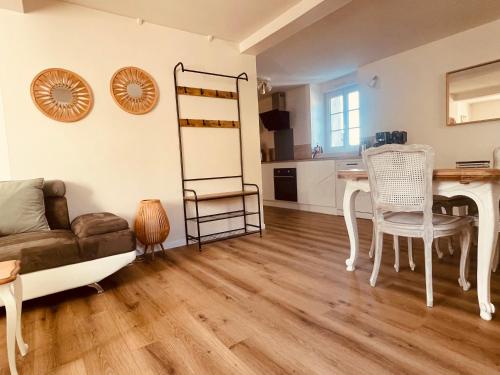 a living room with a couch and a table at Gite proche mer in Cherbourg en Cotentin