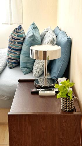 a table with a lamp on it next to a bed at PMP Adamia Apartments in Peyia