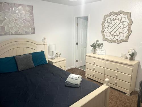 a bedroom with a bed and a dresser at 3 Bed 3 Bath Townhome in Tallahassee