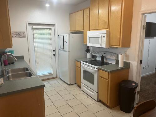 a kitchen with a sink and a stove top oven at 3 Bed 3 Bath Townhome in Tallahassee